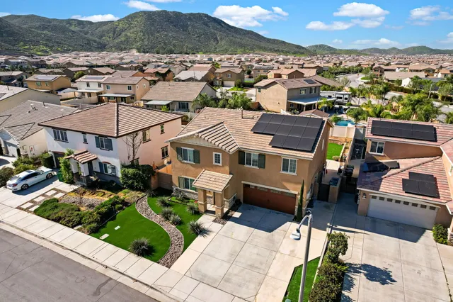 an aerial view of a house with a yard
