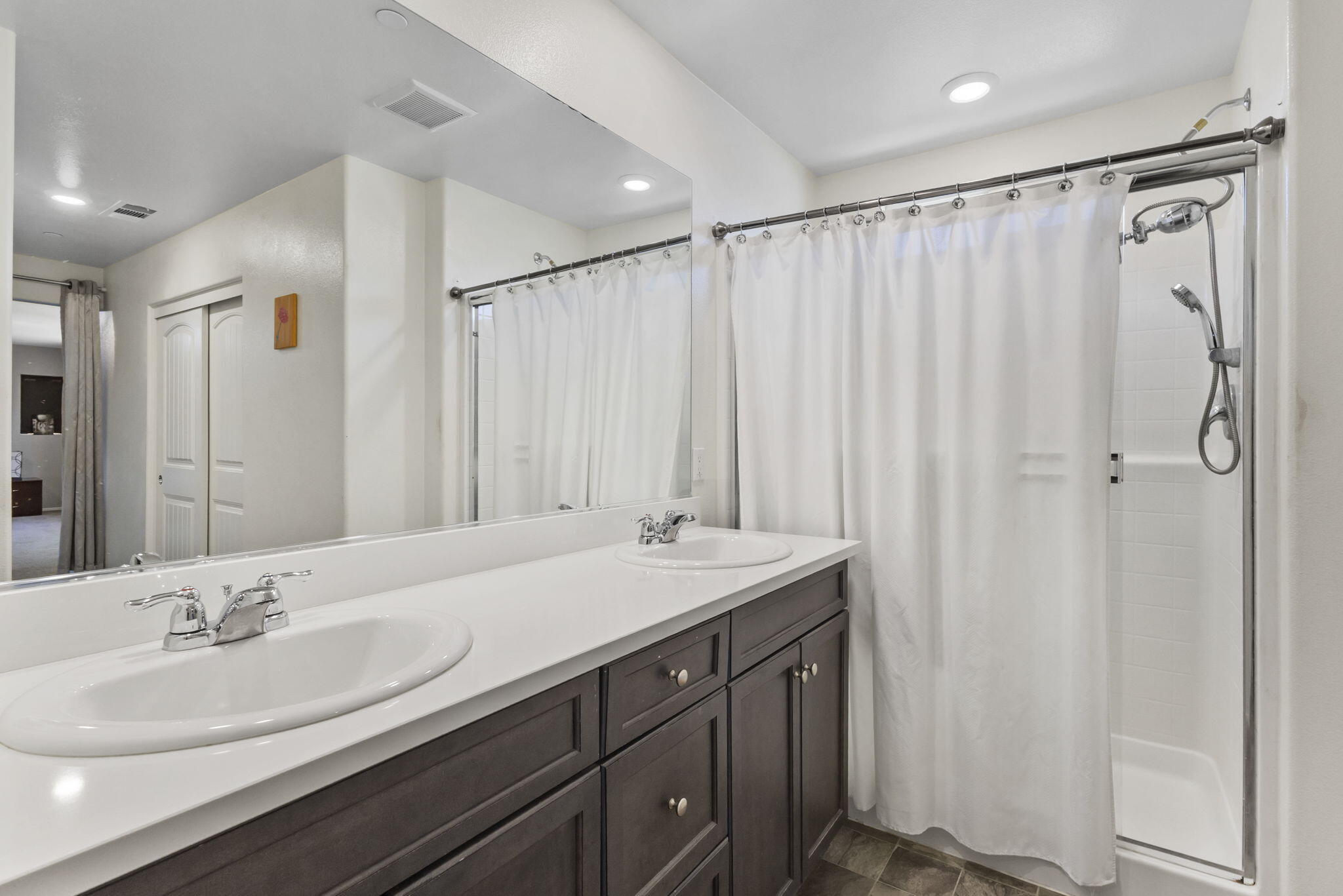 32486 Roman Warren Way Winchester, CA 92596 - Photo 33 of 45 a bathroom with a double vanity sink and a mirror
