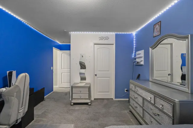 a spacious bedroom with a bed and furniture