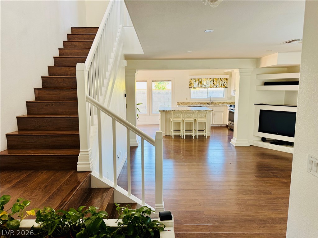 8920 Argus Reed Avenue Las Vegas, NV 89148 - Photo 2 of 10 This inviting interior features a striking wooden staircase and open-concept living, perfect for modern lifestyles.