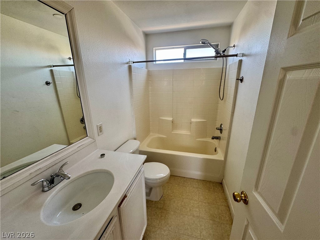 8920 Argus Reed Avenue Las Vegas, NV 89148 - Photo 7 of 10 This clean bathroom features a functional vanity and a combined shower-bathtub for everyday convenience.