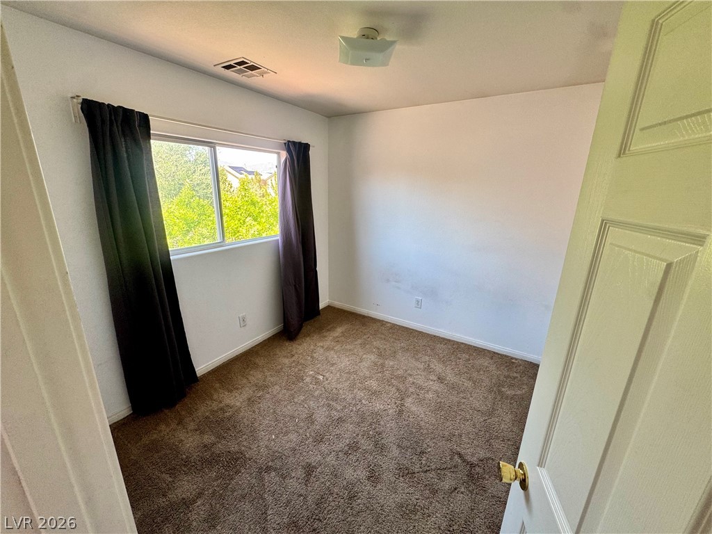 8920 Argus Reed Avenue Las Vegas, NV 89148 - Photo 9 of 10 This cozy room offers a tranquil retreat with soft carpeting and ample natural light.