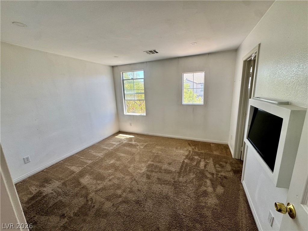 8920 Argus Reed Avenue Las Vegas, NV 89148 - Photo 10 of 10 This spacious room features ample natural light and plush carpeting, offering comfort and versatility.