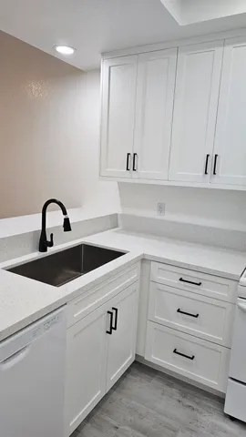 a view white cabinets and a sink