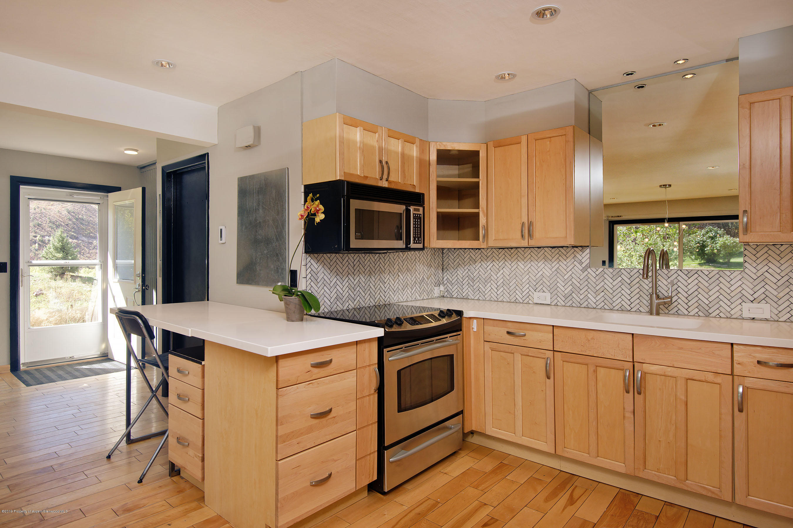 a kitchen with a sink stove and cabinets