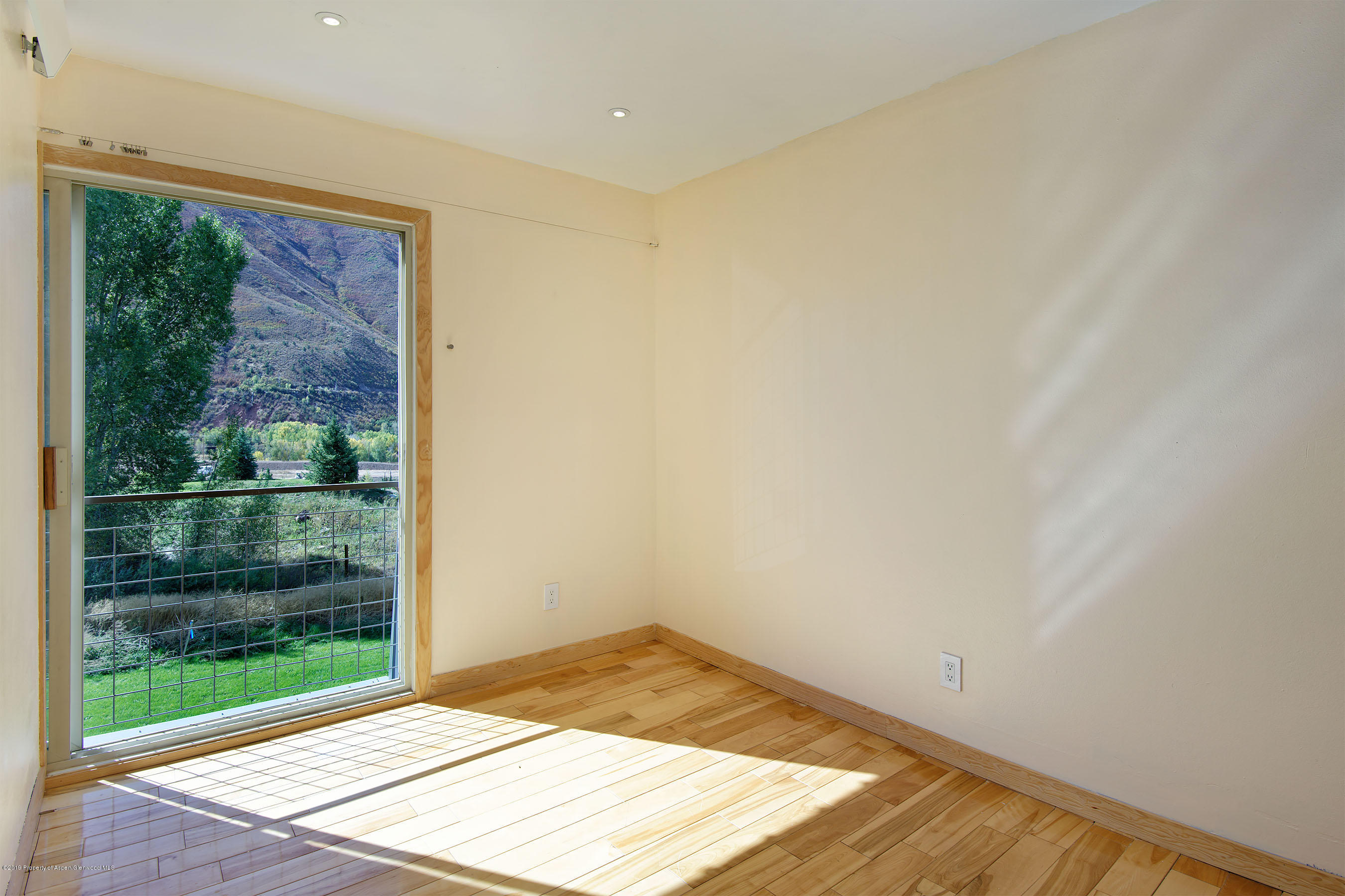 548 Holland Hills Road, Unit 4 Basalt, CO 81621 - Photo 13 of 20 a view of a big room with wooden floor and windows