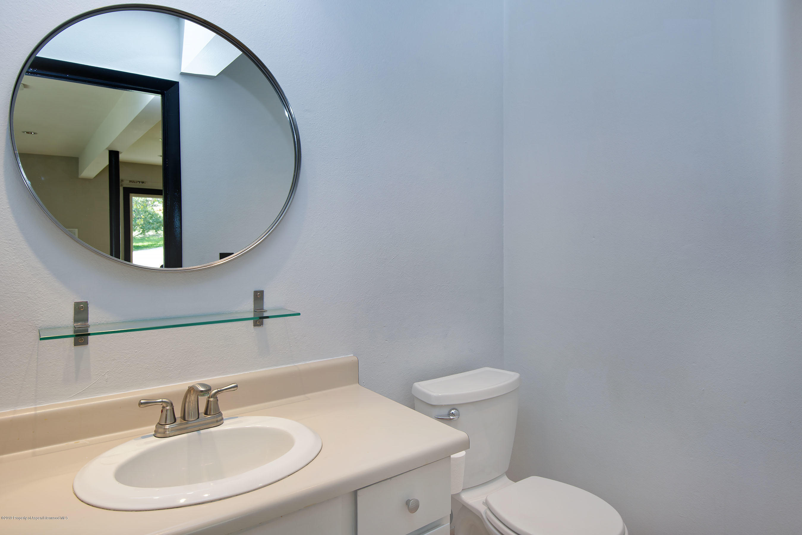 548 Holland Hills Road, Unit 4 Basalt, CO 81621 - Photo 8 of 20 a bathroom with a toilet a sink and mirror