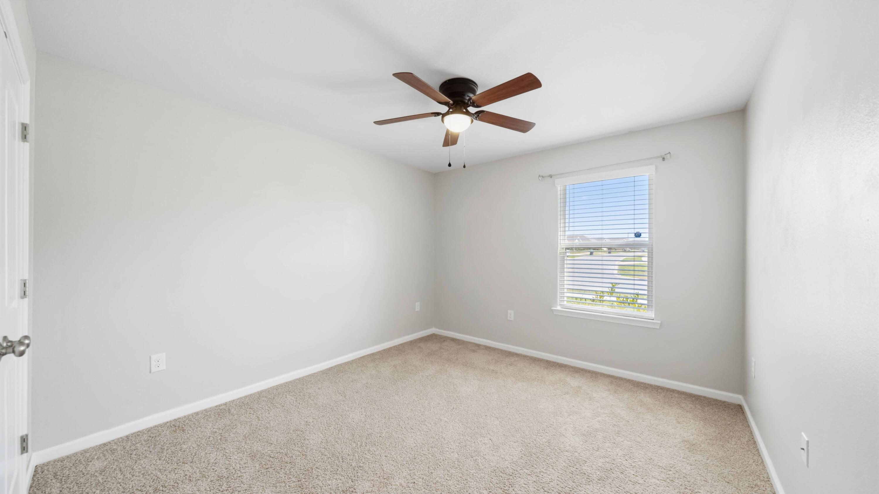 3927 Alva Thomas Road Panama City, FL 32404 - Photo 19 of 46 an empty room with a window and a fan