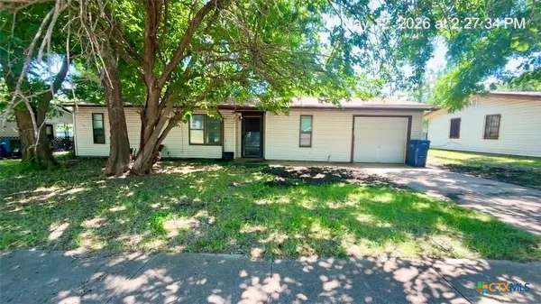a backyard of a house with yard and large tree