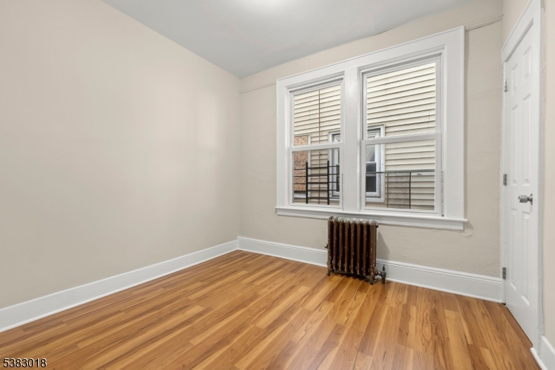 431 South 14th Street Newark, NJ 07103 - Photo 13 of 16 an empty room with wooden floor and windows