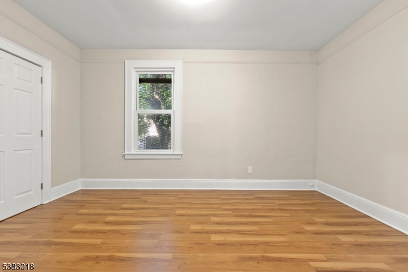431 South 14th Street Newark, NJ 07103 - Photo 14 of 16 a view of an empty room with wooden floor and a window