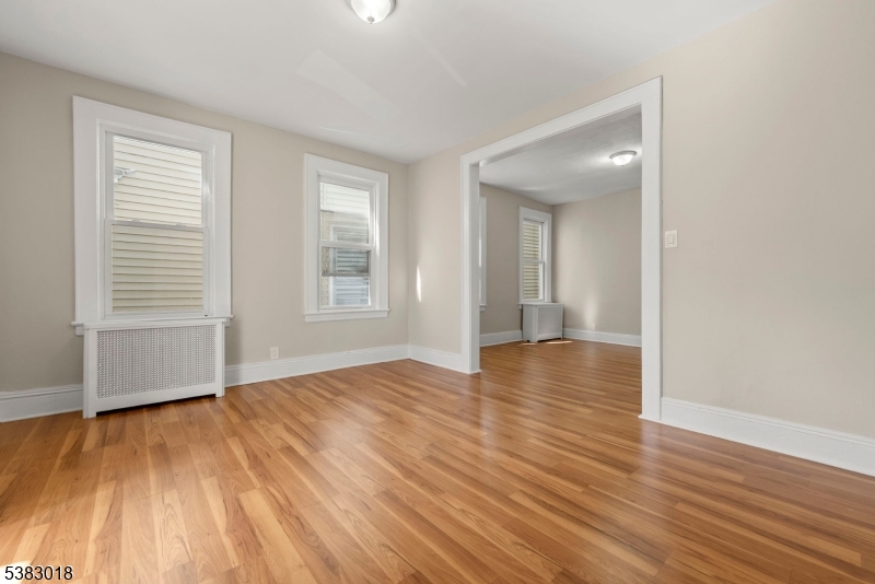 431 South 14th Street Newark, NJ 07103 - Photo 4 of 16 a view of an empty room with wooden floor and a window