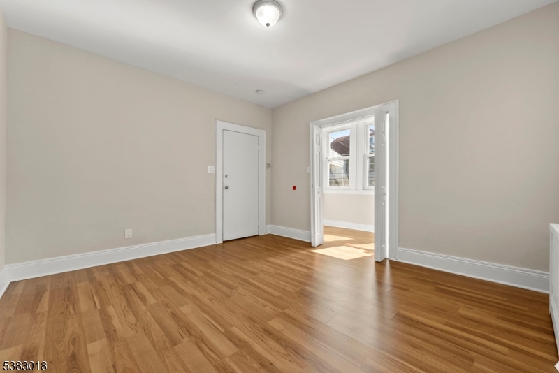 431 South 14th Street Newark, NJ 07103 - Photo 5 of 16 a view of an empty room with wooden floor