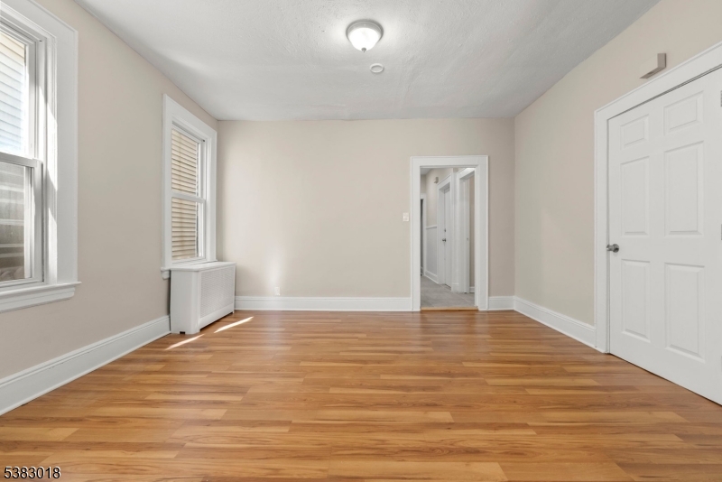 431 South 14th Street Newark, NJ 07103 - Photo 7 of 16 a view of an empty room with wooden floor and a window