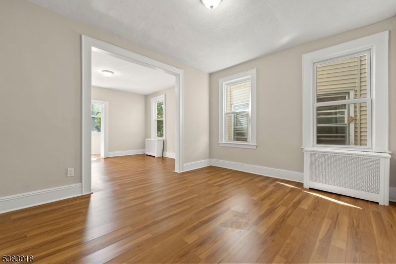 431 South 14th Street Newark, NJ 07103 - Photo 8 of 16 a view of an empty room with wooden floor and a window