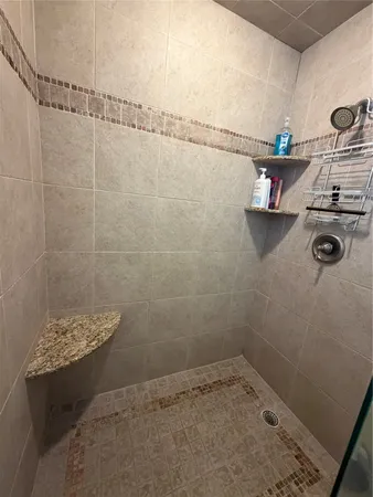 a en suite bathroom with a granite countertop sink and a mirror