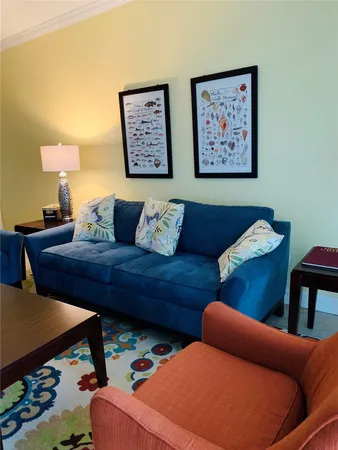 a living room with furniture and a lamp