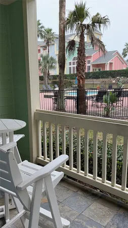 a view of a building with a porch and furniture
