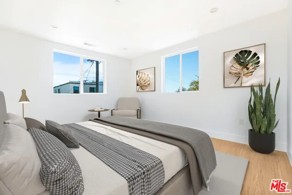 a bedroom with a bed and a couch