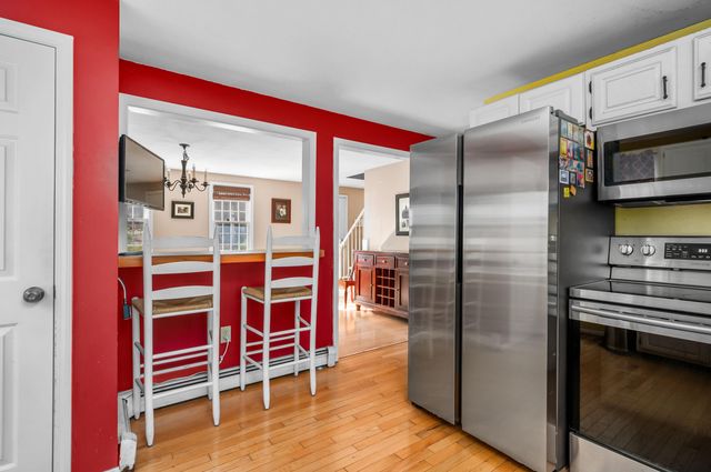 a bathroom with a granite countertop sink toilet and mirror