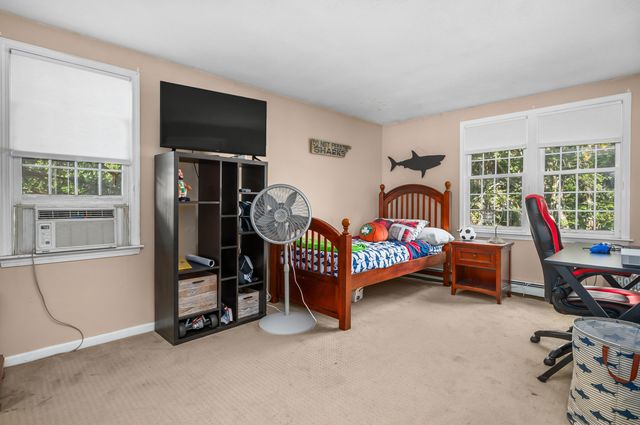a bedroom with furniture and a window