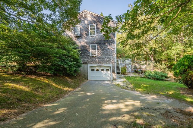 a view of a large building with a big yard and large trees