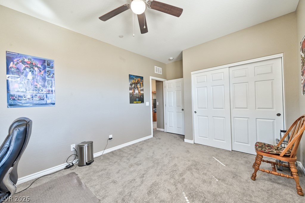 1054 Langston Ranch Avenue Henderson, NV 89002 - Photo 41 of 82 Bedroom 2 can be Home office with light carpet and ceiling fan