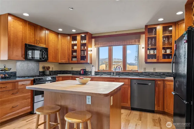 a room with a black white checkered floor with a gaming machine and wooden floor