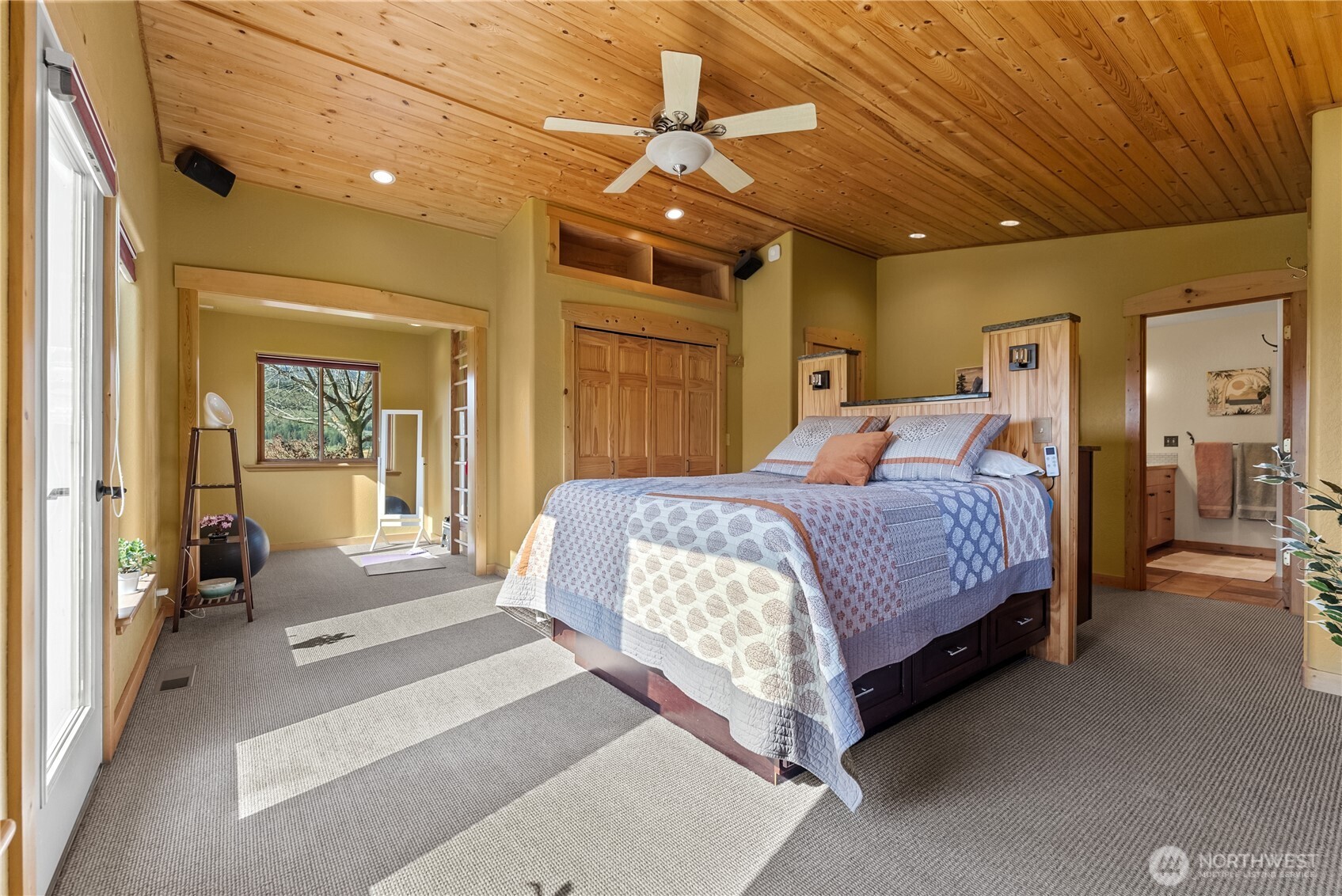 75 Rolling Rock Road Winthrop, WA 98862 - Photo 19 of 40 a bedroom with a large bed and a chandelier