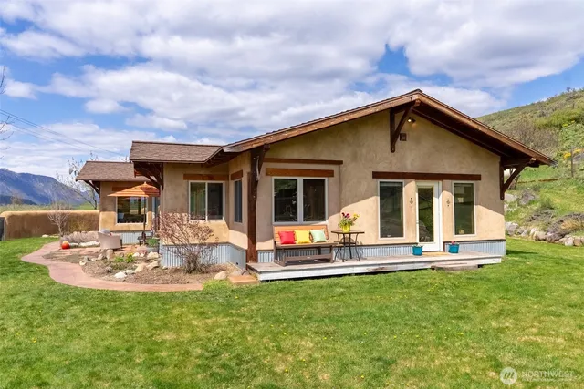 a kitchen with stainless steel appliances granite countertop a refrigerator a sink a stove and a wooden floors