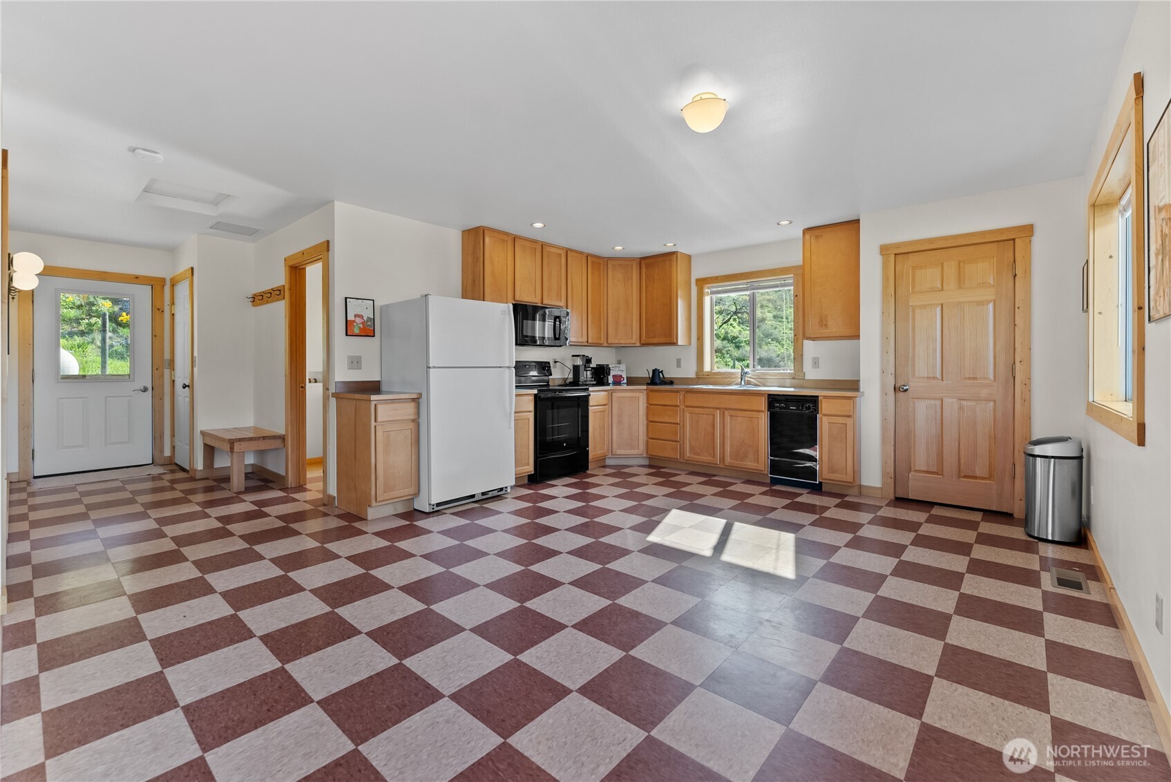 75 Rolling Rock Road Winthrop, WA 98862 - Photo 35 of 40 a kitchen with a checkered floor and black cabinets