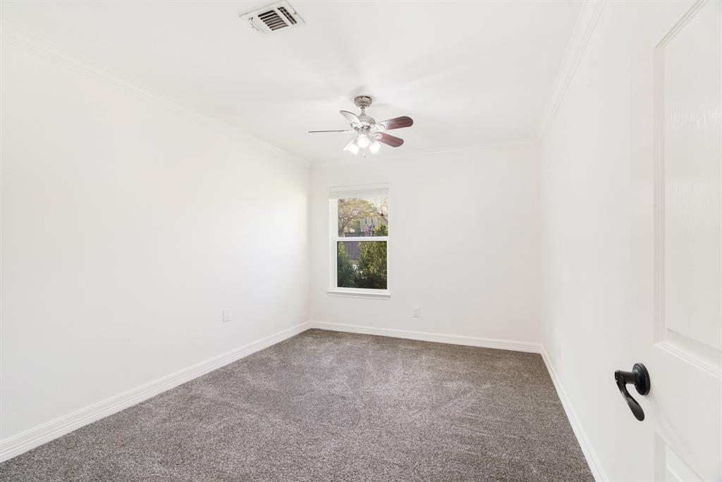 220 Laredo Drive Reno, TX 75462 - Photo 13 of 24 an empty room with windows and fan