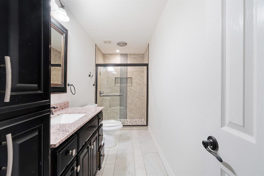 220 Laredo Drive Reno, TX 75462 - Photo 14 of 24 a bathroom with a sink and a mirror