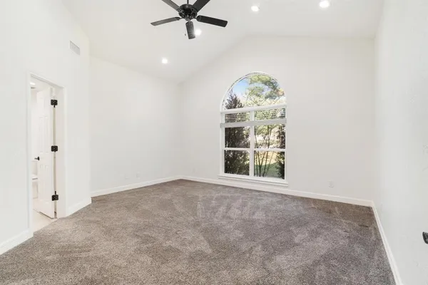 an empty room with windows and closet