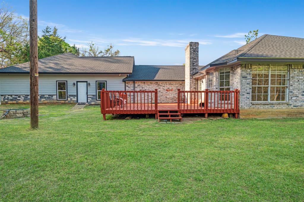 220 Laredo Drive Reno, TX 75462 - Photo 23 of 24 a front view of a house with garden