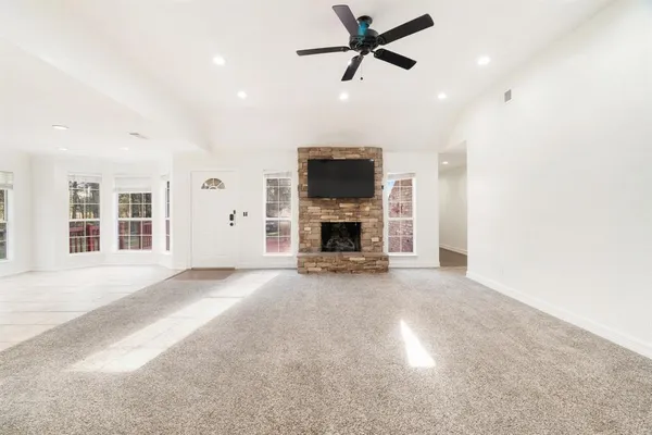 a big room with windows and a fireplace