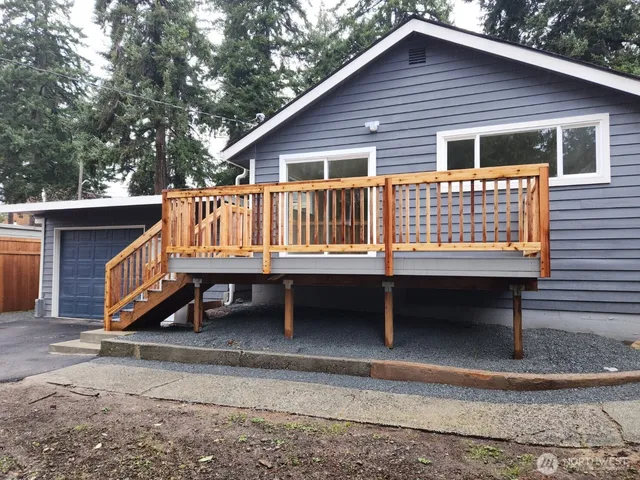 a kitchen with a sink cabinets wooden floor and stainless steel appliances