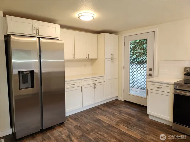 a kitchen with stainless steel appliances a refrigerator sink and cabinets