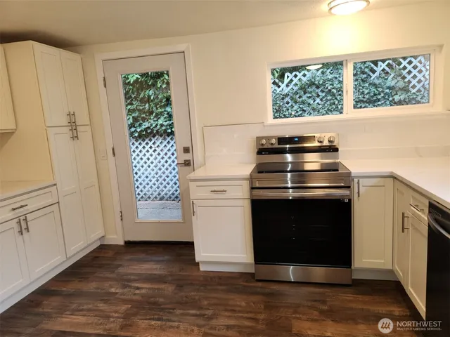a kitchen with a stove and a white cabinet