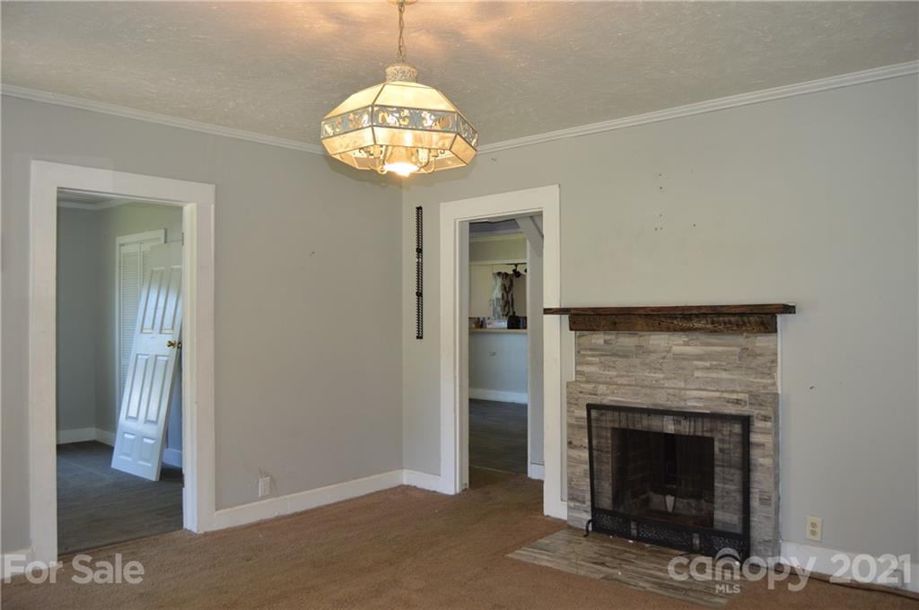 65 Alexander Road Stony Point, NC 28678 - Photo 4 of 19 a view of a livingroom with a chandelier and fireplace