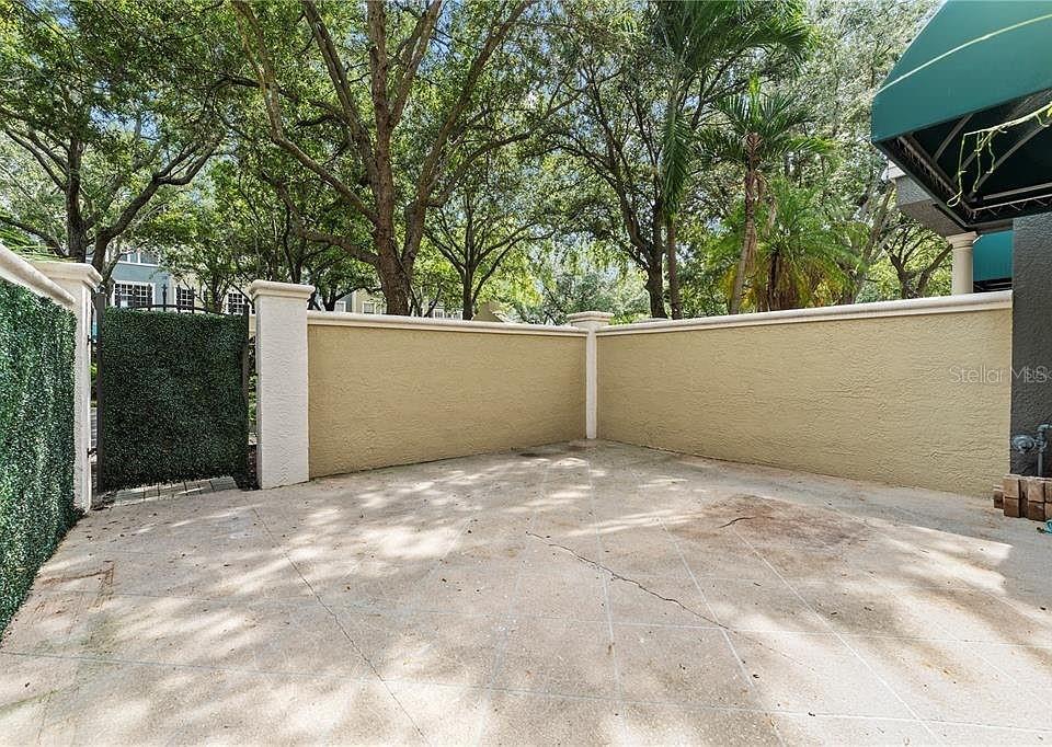 1437 Harbour Walk Road Tampa, FL 33602 - Photo 32 of 32 a backyard of a house with large trees and garage