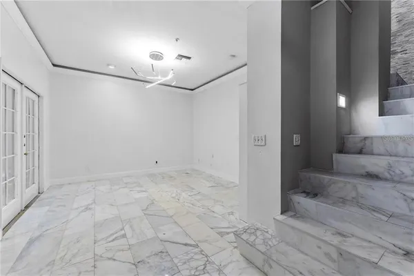 a spacious bedroom with a bed and a window