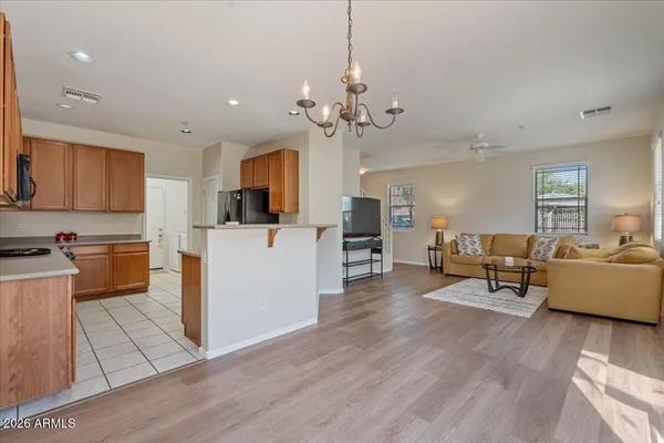 a living room with furniture and kitchen view