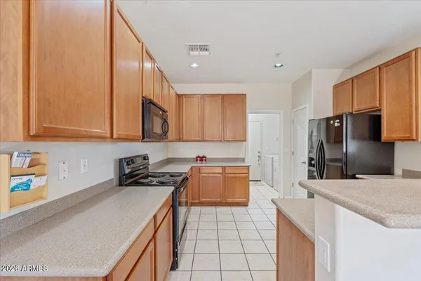 a kitchen with stainless steel appliances a sink stove and refrigerator