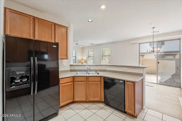a kitchen with a sink a refrigerator and cabinets