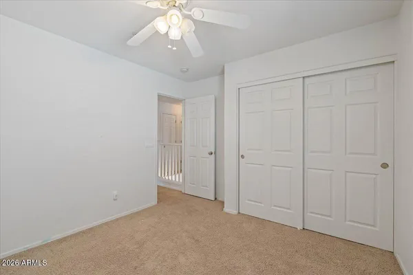 an empty room with a chandelier fan