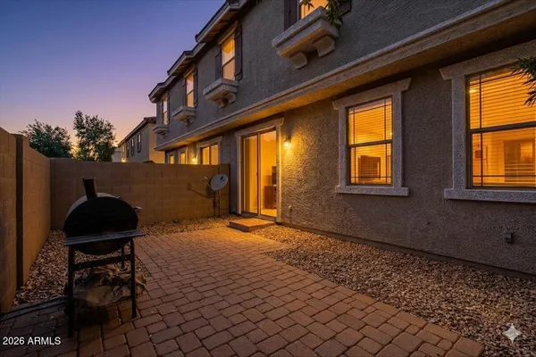 a backyard of a house with table and chairs