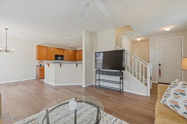 a view of a kitchen with wooden floor and electronic appliances