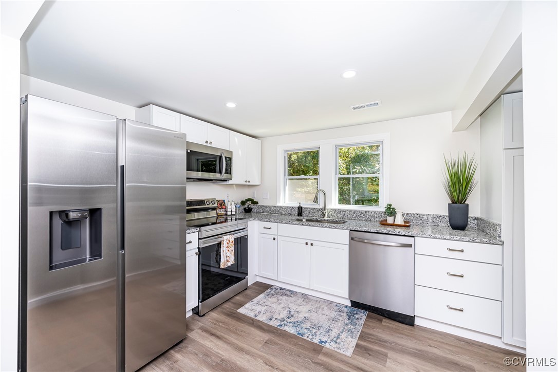 17314 Hewlett Road Beaverdam, VA 23015 - Photo 6 of 16 a kitchen with a sink stainless steel appliances and cabinets
