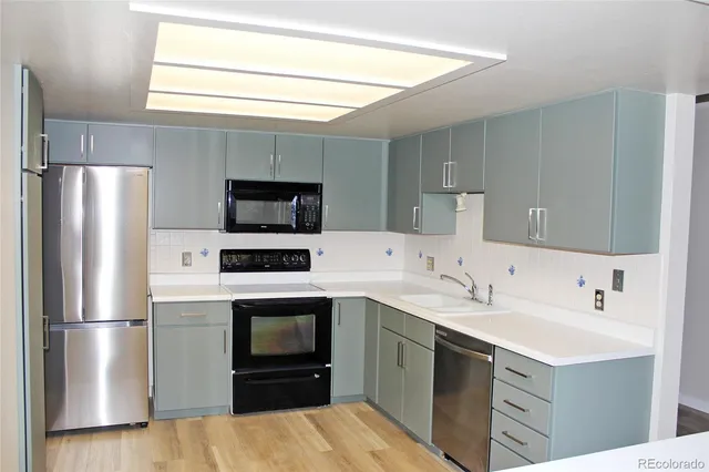a kitchen with a sink stainless steel appliances and cabinets